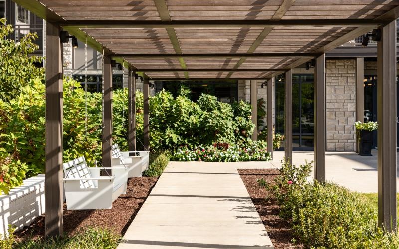 a covered patio with a walkway