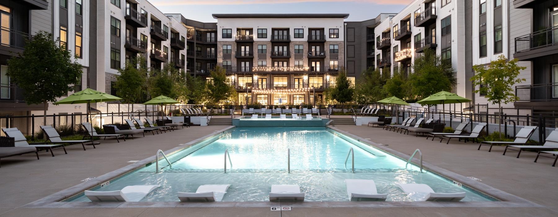 a pool in a courtyard between buildings