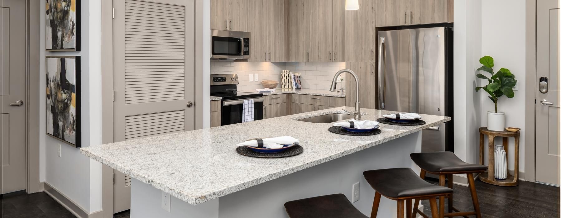 a kitchen with a marble island