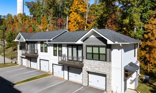exterior of building with green turf and some seating