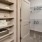 a closet with a door and shelves