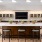 a kitchen with a tv bar and chairs